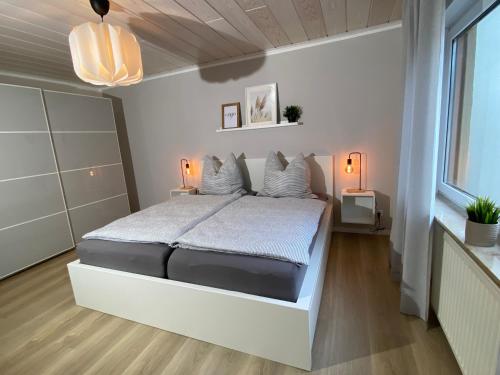 a bedroom with a large bed with white sheets and pillows at Ferienwohnung Loreley Mittelrheintal in Sankt Goar