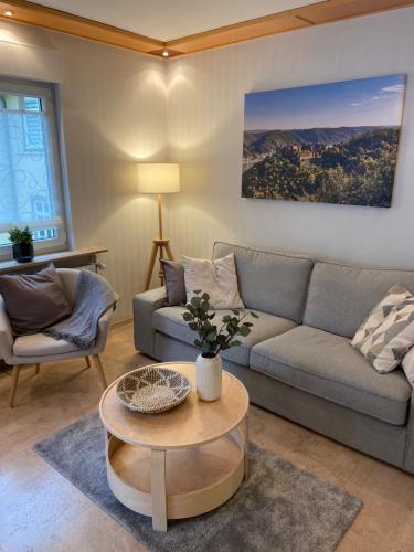 a living room with a couch and a table at Ferienwohnung Loreley Mittelrheintal in Sankt Goar