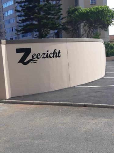 a white retaining wall with a k coefficient sign on it at 65 @ Zeezicht in Kingsburgh