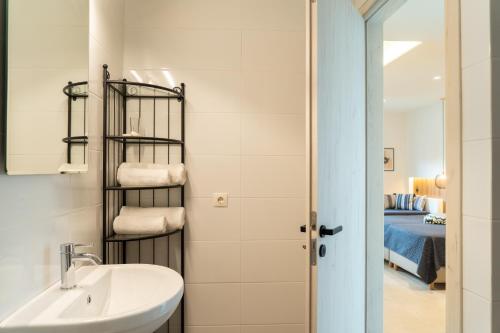 a bathroom with a sink and a towel rack at Esperos Studios and Apartments, #1 and #5 in Stalís