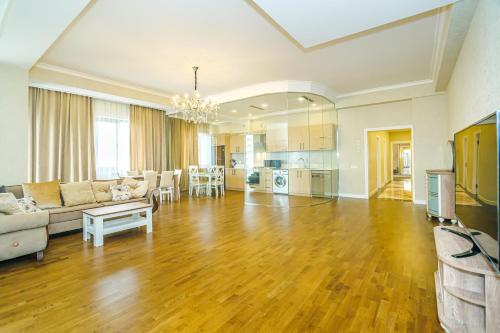 a large living room with a couch and a table at Buta Palace Luxury House in Baku