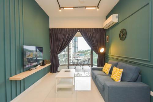 a living room with a couch and a tv at Country Garden Seaview Suite by Nest Home at Danga Bay in Johor Bahru
