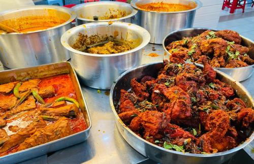 a bunch of dishes of food on a table at ESSY Hotel KL Sentral in Kuala Lumpur