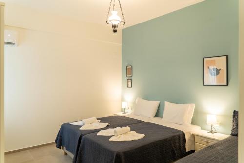 a bedroom with a bed with two towels on it at Esperos Studios and Apartments, #6 in Stalida