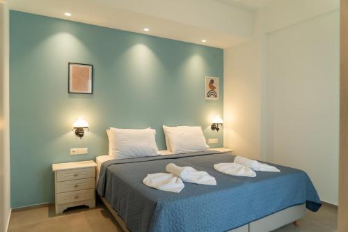 a bedroom with a bed with two towels on it at Esperos Studios and Apartments, #6 in Stalida