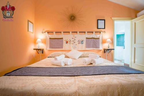 1 dormitorio con 1 cama grande y toallas. en Romeo & Giulietta rooms, en Bosa