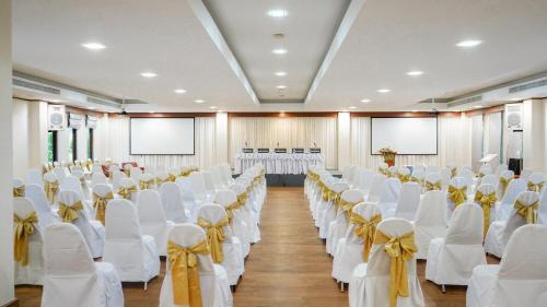 a room with rows of white chairs with yellow bows at Bor Saen Pool Villa in Bor Saen