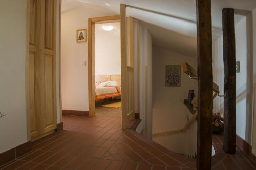 a hallway with an open door leading to a bedroom at Apartmaji in sobe Marija Jera Štanjel in Štanjel