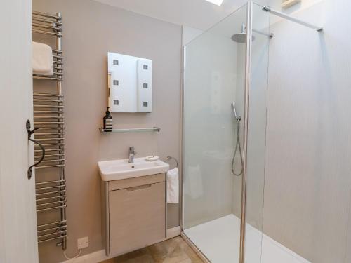 a bathroom with a shower and a sink at The Bothy at Snape Hall in Snape