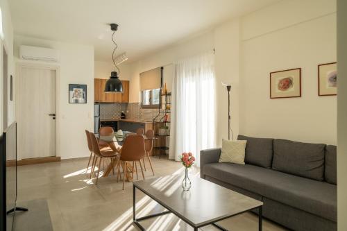 a living room with a couch and a table at Esperos Studios and Apartments, #6 in Stalida