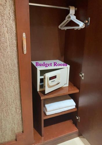 a microwave on a shelf in a room at Le Tanjong House in Patong Beach