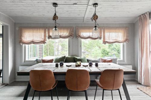 a dining room with a large table and chairs at Luxury family home near the water for eight people in Stockholm