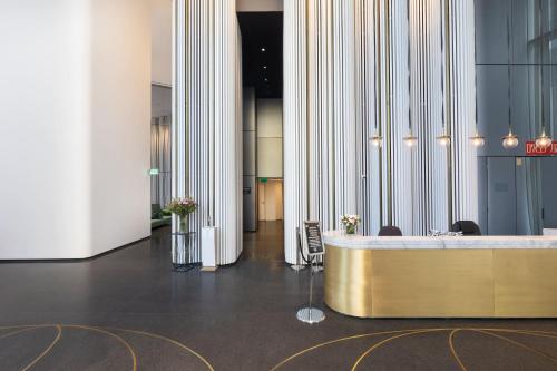 a lobby with a reception desk and columns at Tel Aviv Vacation Apartments in Tel Aviv