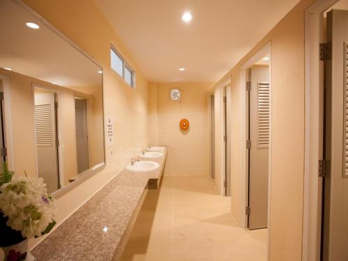 a large bathroom with two sinks and two mirrors at Studio'Z in Chiang Mai