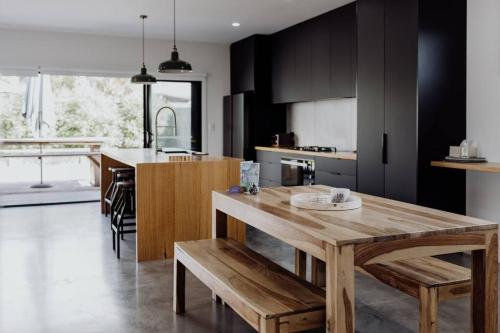 a kitchen with a wooden table and a dining room at Scandi at Stieglitz Sleeps 6 Modern & Stylish in St Helens