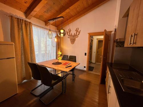 a kitchen and dining room with a table and chairs at Haus Eder Steiner in Saalbach Hinterglemm