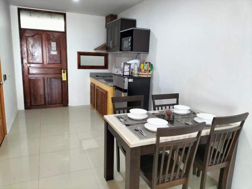 a kitchen with a table and chairs in a room at Beach Home Lanta in Ko Lanta