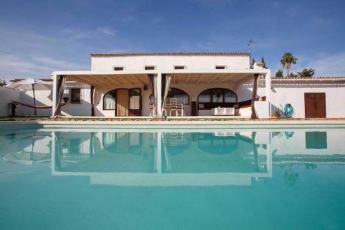 a house with a swimming pool in front of a house at Villa Casa de campo Atrapasomnis in Benissa