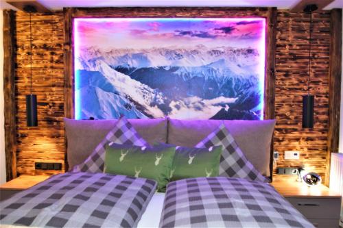 a bedroom with a bed with a painting on the wall at Eisenberg - Komfortables, helles Apartment mit Balkon und Alpenblick ruhig gelegen in Pfronten Mitte in Pfronten