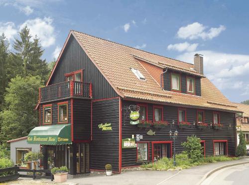 a large black building with a red roof at Landhaus Meyer in Riefensbeek