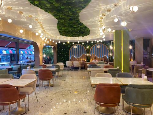 a dining room with tables and chairs and a ceiling at Gloria Suite Hotel in Trabzon