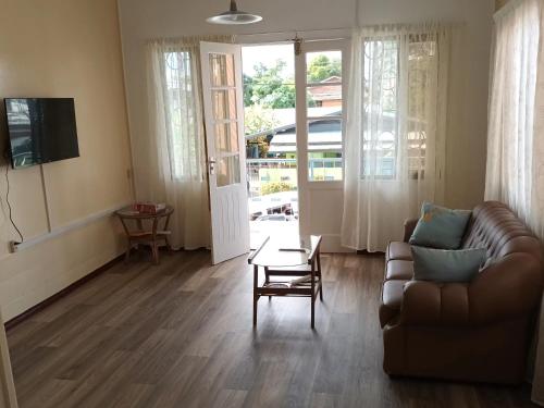 a living room with a couch and a table at Max Garden and Pool in Paramaribo