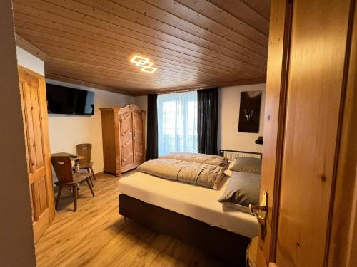 a bedroom with a large bed in a wooden room at Haus Eder Steiner in Saalbach Hinterglemm