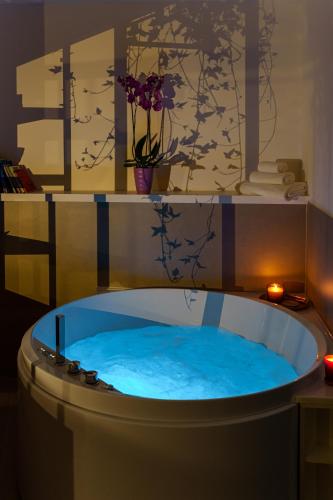 a jacuzzi tub with blue water in a room at Urban Karalis by Accomodo in Cagliari
