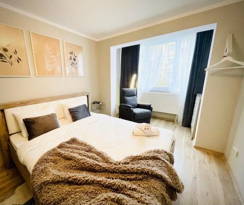 sypialnia z dużym łóżkiem z kocem w obiekcie Hygge place to stay - self check in nonstop 24h-wifi w mieście Reşiţa
