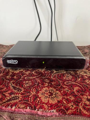 a laptop computer sitting on top of a rug at Sofea Homestay Ipoh in Ipoh