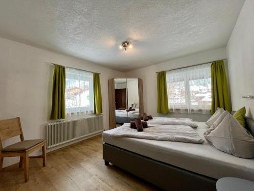 une chambre avec un grand lit avec des rideaux verts dans l'établissement Ferienwohnung Wetterstein, à Lermoos