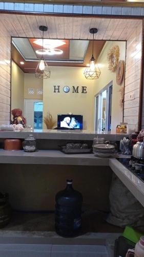 a kitchen counter with a mirror and a tv on it at Villa atas awan in Wonosobo