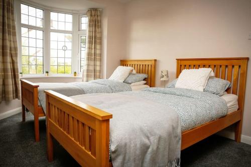 two twin beds in a bedroom with a window at Hidden Gem Canal Facing Retreat with lovely walks in Hopwas