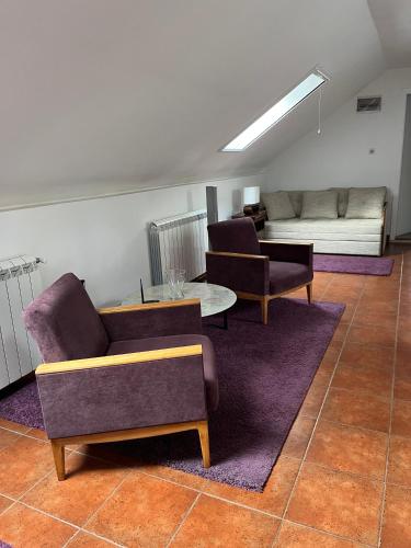 a living room with two chairs and a couch at Apartment Dixy in Belgrade