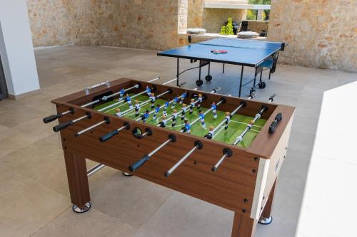 a ping pong table with a ping pong ball at Lemon Tree Villa in Gialova