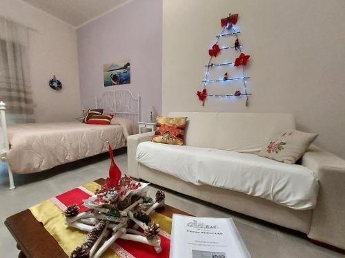 a living room with a christmas tree on the wall at B&B Petra Hercules in Torre Annunziata