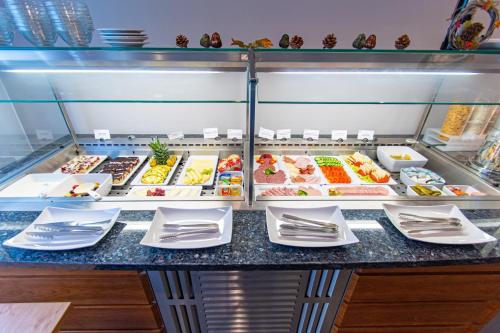 a buffet line with many different types of food at Taste Hotel Hockenheim in Hockenheim