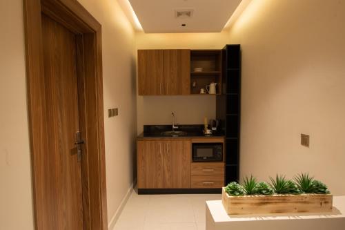 a kitchen with a sink and a counter with plants at Grand day in Al Hofuf