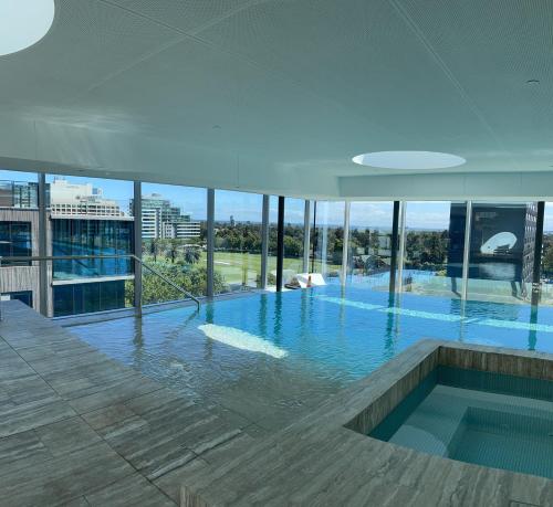 a large swimming pool on top of a building at The Fawkner Apartment Bay-view pool/Gym Free Parking in Melbourne