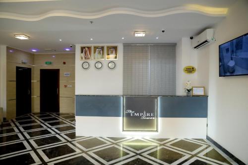 a lobby with a counter in a building at Empire Apartments in Juffair