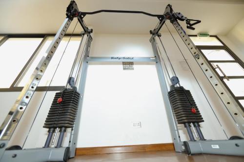 a room with three windows and three ladders at Empire Apartments in Juffair