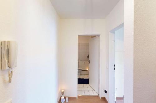 a hallway with a phone in a white room at Wohlfühl-Wohnen in Düren in Düren - Eifel