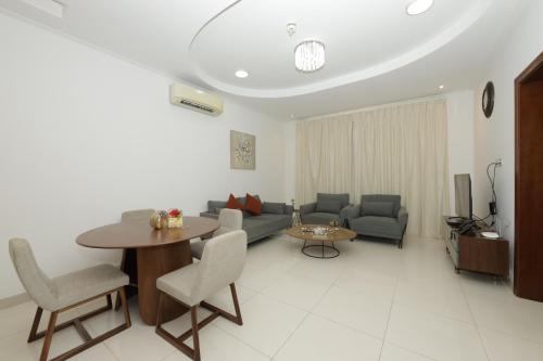 a living room with a couch and a table at Empire Apartments in Juffair