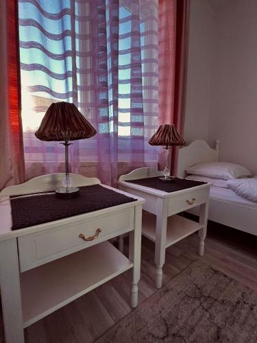 two tables with lamps on them in a bedroom at Råda Hotel in Hagfors