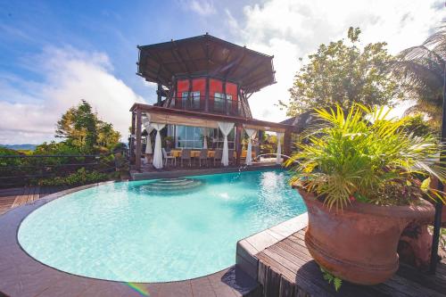 a house with a swimming pool with a tower at Sinurambi Cottage Rental in Penampang