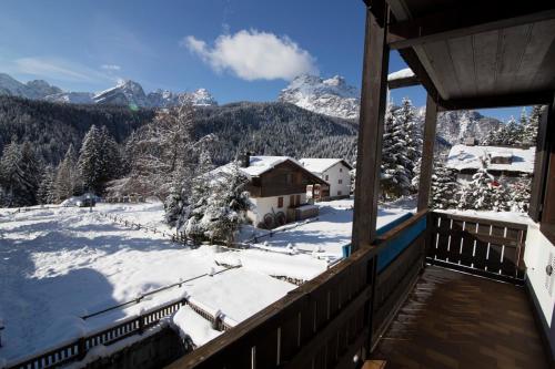 a balcony with a view of a snow covered mountain at RESIDENCE-RESORT BORGO AL SOLE in Sappada