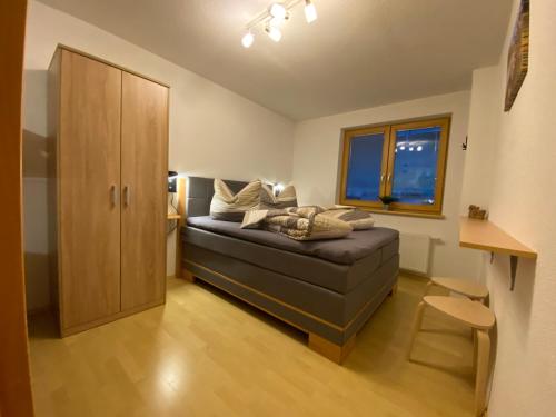 a living room with a couch and a cabinet at Pension Jagerhof - Sommercard Inkl - 5 Min zum Hochzeiger in Jerzens