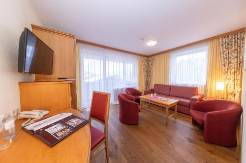 a living room with a couch and a table at VÖTTER'S HOTEL in Kaprun - summer card included in Kaprun