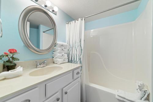 a bathroom with a sink and a mirror at Perdido Towers East 106 in Perdido Key