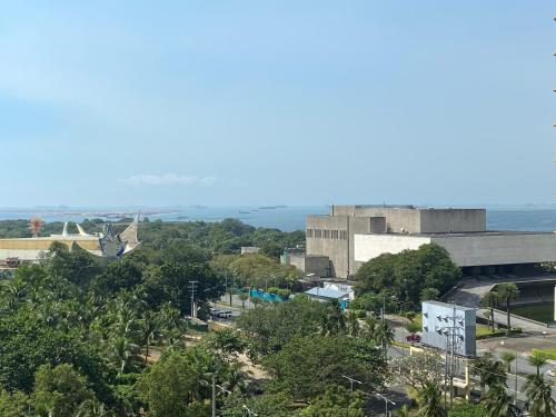 a view of a city with the ocean in the background at Le 10 The Radiance Manila Bay in Manila